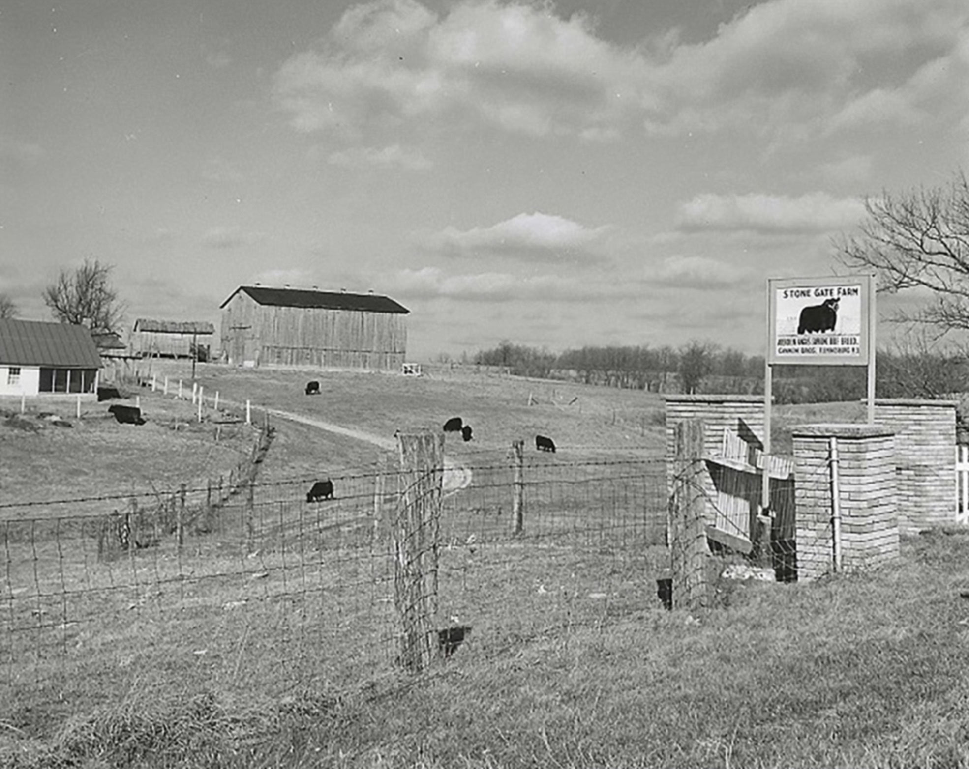 Black and white photo of entrance gate and Farm