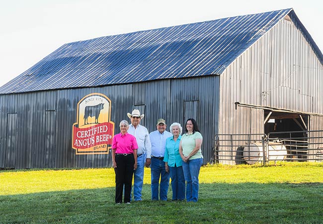 Cannon family in front of CAB painted barn