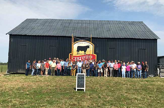 Large group of people in front of CAB painted barn